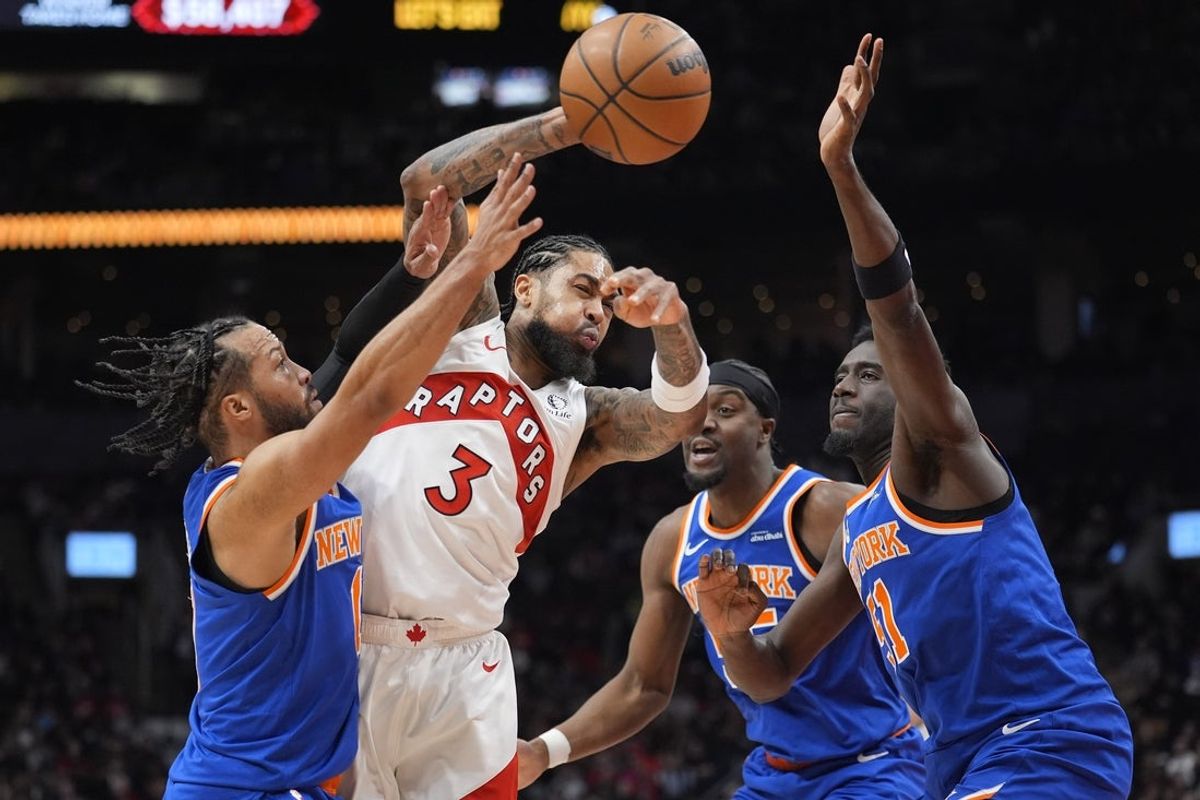 Jan 28, 2026; Toronto, Ontario, CAN; New York Knicks guard Jalen Brunson (11) and center Ariel Hukporti (55) and forward Mohamed Diawara (51) defend against Toronto Raptors forward Brandon Ingram (3) during the second half at Scotiabank Arena. Mandatory Credit: John E. Sokolowski-Imagn Images