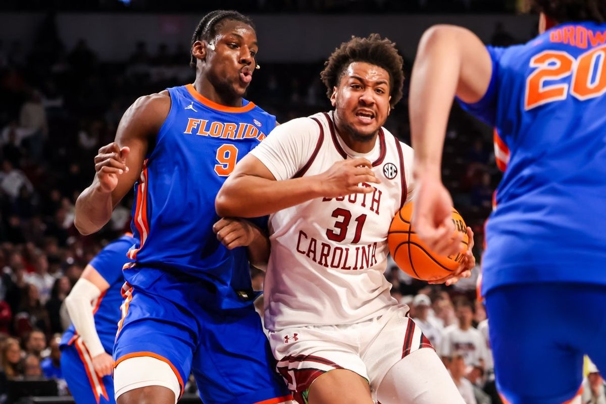 Jan 28, 2026; Columbia, South Carolina, USA; South Carolina Gamecocks forward Elijah Strong (31) attempts to driver around Florida Gators center Rueben Chinyelu (9) in the first half at Colonial Life Arena. Mandatory Credit: Jeff Blake-Imagn Images
