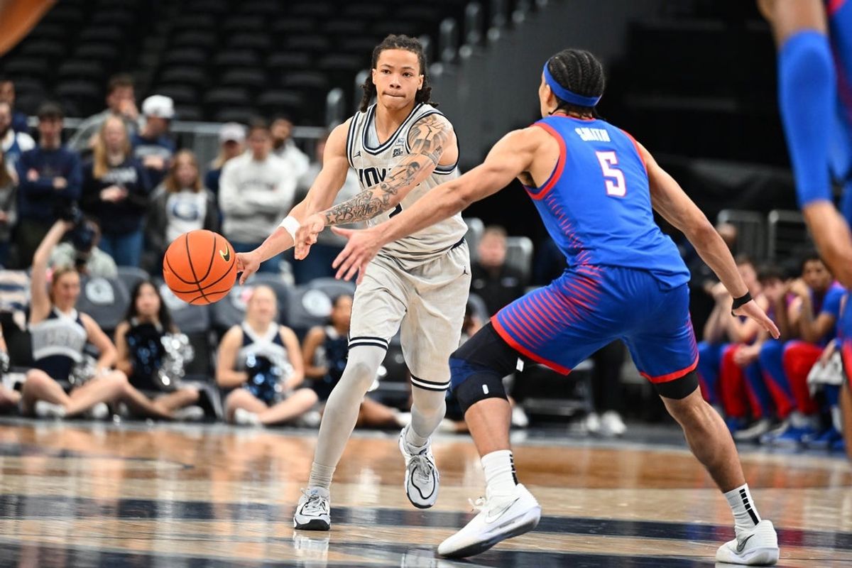 Jan 28, 2026; Washington, District of Columbia, USA; Georgetown Hoyas guard Malik Mack (2) looks to pass as DePaul Blue Demons guard RJ Smith (5) defends during the second half at Capital One Arena. Mandatory Credit: Brad Mills-Imagn Images