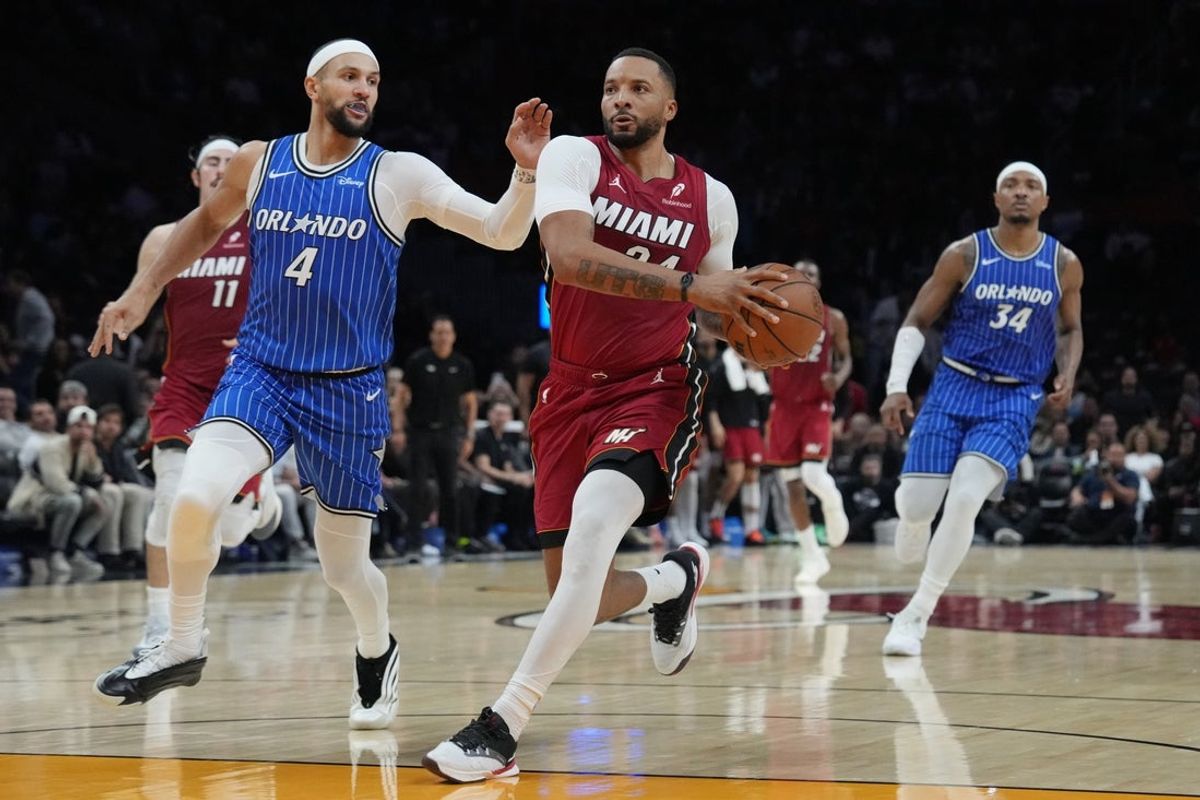 Jan 28, 2026; Miami, Florida, USA;  Miami Heat guard Norman Powell (24) drives to the basket as Orlando Magic guard Jalen Suggs (4) follows on the play during the second half at Kaseya Center. Mandatory Credit: Jim Rassol-Imagn Images