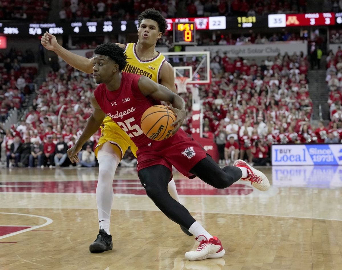 Wisconsin guard John Blackwell (25) turns the corner on Minnesota guard Isaac Asuma (1) during the second half of their game Wednesday, January 28, 2026 at the Kohl Center in Madison, Wisconsin. Wisconsin beat Minnesota 67-63.