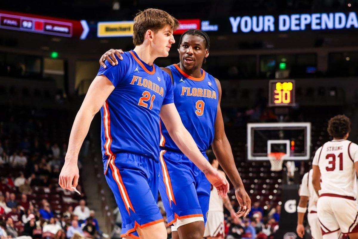Jan 28, 2026; Columbia, South Carolina, USA; Florida Gators forward Alex Condon (21) and center Rueben Chinyelu (9) chat against the South Carolina Gamecocks in the second half at Colonial Life Arena. Mandatory Credit: Jeff Blake-Imagn Images