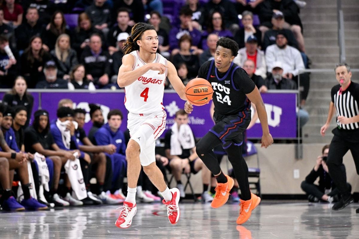 Jan 28, 2026; Fort Worth, Texas, USA; Houston Cougars guard Kingston Flemings (4) brings the ball up court past TCU Horned Frogs forward Xavier Edmonds (24) during the second half at Ed and Rae Schollmaier Arena. Mandatory Credit: Jerome Miron-Imagn Images