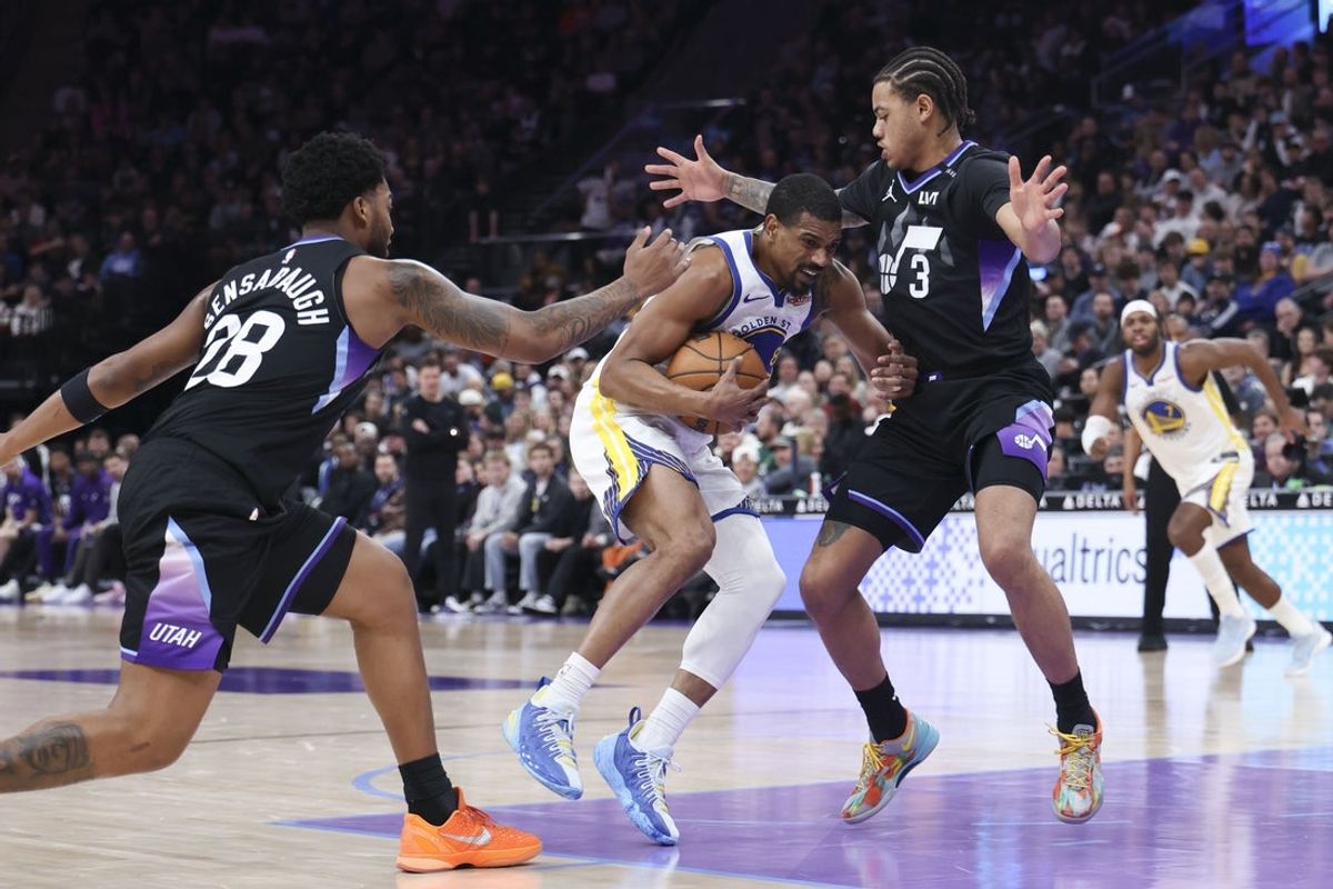 Jan 28, 2026; Salt Lake City, Utah, USA; Golden State Warriors guard De'anthony Melton (middle) goes to the basket against Utah Jazz forward Brice Sensabaugh (28) and guard Keyonte George (3) during the second half at Delta Center. Mandatory Credit: Rob Gray-Imagn Images