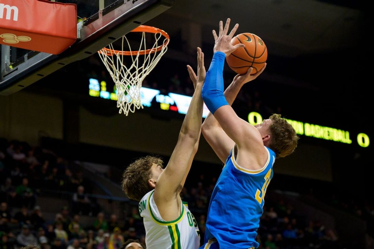 UCLA forward Tyler Bilodeau goes up over Oregon forward Luke Johnson as the Oregon Ducks host the UCLA Bruins on Jan. 28, 2026, at Matthew Knight Arena in Eugene, Oregon.