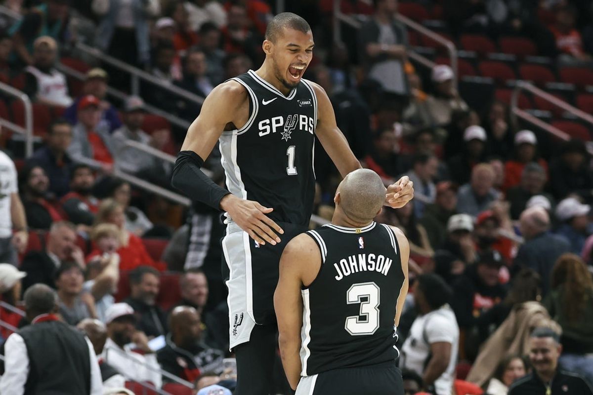 Jan 28, 2026; Houston, Texas, USA; San Antonio Spurs forward Victor Wembanyama (1) celebrates with forward Keldon Johnson (3) after Johnson scores a basket during the fourth quarter against the Houston Rockets at Toyota Center. Mandatory Credit: Troy Taormina-Imagn Images
