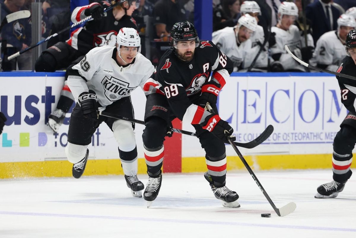 Jan 29, 2026; Buffalo, New York, USA;  Buffalo Sabres right wing Alex Tuch (89) skates with the puck as Los Angeles Kings left wing Jeff Malott (39) tries to defend during the second period at KeyBank Center. Mandatory Credit: Timothy T. Ludwig-Imagn Images