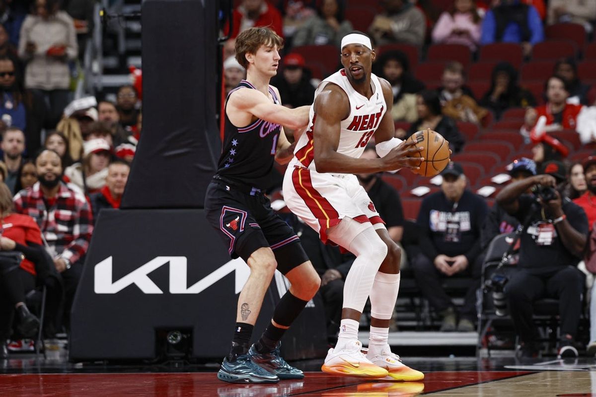 Jan 29, 2026; Chicago, Illinois, USA; Chicago Bulls forward Matas Buzelis (14) defends against Miami Heat center Bam Adebayo (13) during the first half at United Center. Mandatory Credit: Kamil Krzaczynski-Imagn Images
