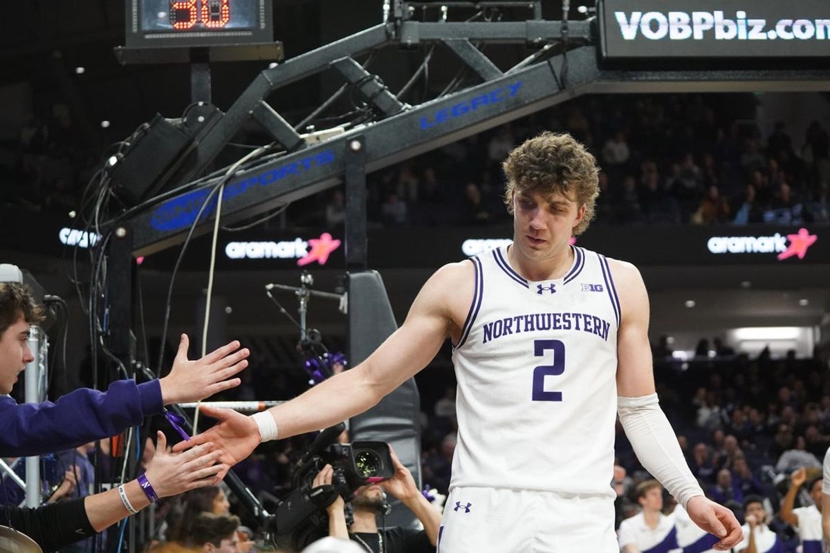Jan 29, 2026; Evanston, Illinois, USA; Northwestern Wildcats forward Nick Martinelli (2) high fives fans after scoring against the Penn State Nittany Lions during the second half at Welsh-Ryan Arena. Mandatory Credit: David Banks-Imagn Images