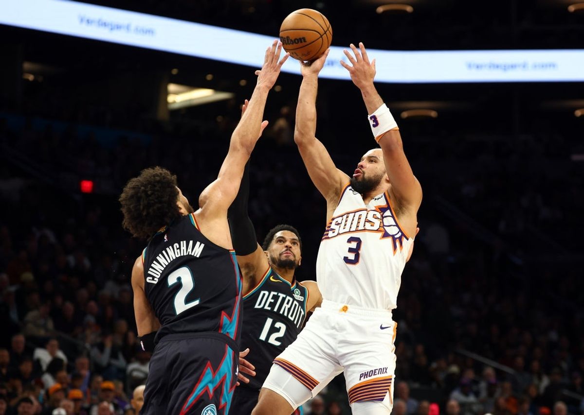 Jan 29, 2026; Phoenix, Arizona, USA; Detroit Pistons guard Cade Cunningham (2) and forward Tobias Harris (12) defend against Phoenix Suns forward Dillon Brooks (3) in the first half at Mortgage Matchup Center. Mandatory Credit: Mark J. Rebilas-Imagn Images