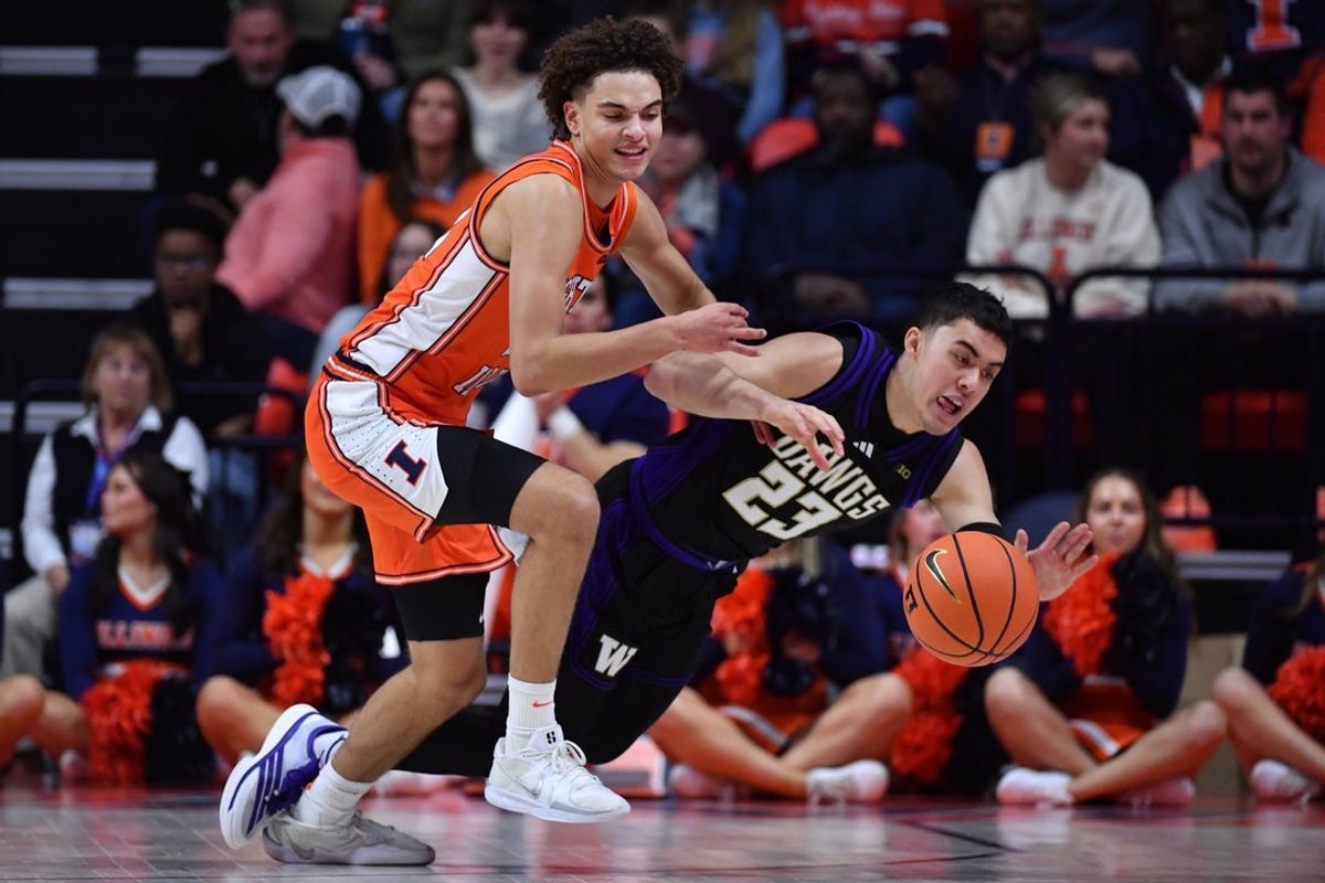 Jan 29, 2026; Champaign, Illinois, USA;  Illinois Fighting Illini guard Keaton Wagler (23) and Washington Huskies guard JJ Mandaquit (23) vie for the ball during the first half at State Farm Center. Mandatory Credit: Ron Johnson-Imagn Images