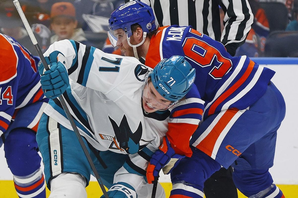Jan 29, 2026; Edmonton, Alberta, CAN; San Jose Sharks forward Macklin Celebrini (71) and Edmonton Oilers forward Connor McDavid (97) battle for a loose puck during the second period at Rogers Place. Mandatory Credit: Perry Nelson-Imagn Images