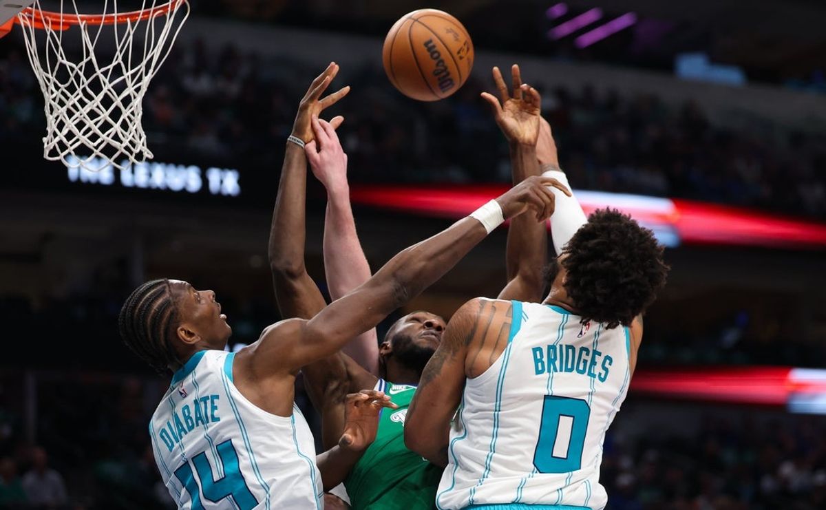 Jan 29, 2026; Dallas, Texas, USA;  Dallas Mavericks center Moussa Cisse (30) battles for the ball with Charlotte Hornets forward Miles Bridges (0) and Charlotte Hornets forward Moussa Diabate (14) during the second half at American Airlines Center. Mandatory Credit: Kevin Jairaj-Imagn Images