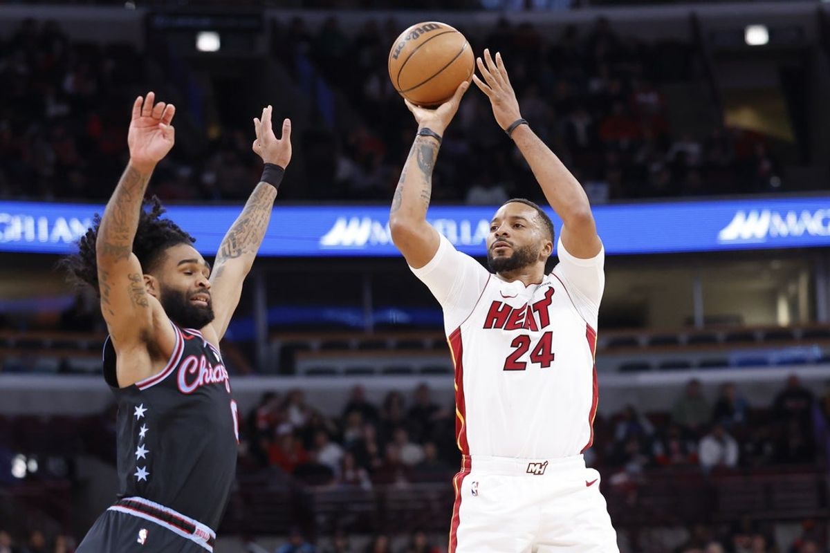 Jan 29, 2026; Chicago, Illinois, USA; Miami Heat guard Norman Powell (24) shoots against Chicago Bulls guard Coby White (0) during the second half at United Center. Mandatory Credit: Kamil Krzaczynski-Imagn Images
