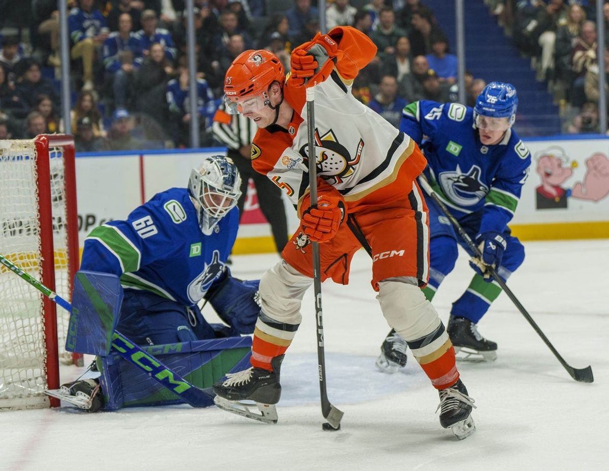 Jan 29, 2026; Vancouver, British Columbia, CAN;  Anaheim Ducks Right Wing Beckett Sennecke (45) plays the puck between his legs in front of Vancouver goaltender Nikita Tolopilo (60) in the second period at Rogers Arena. Mandatory Credit: Christopher Morris-Imagn Images