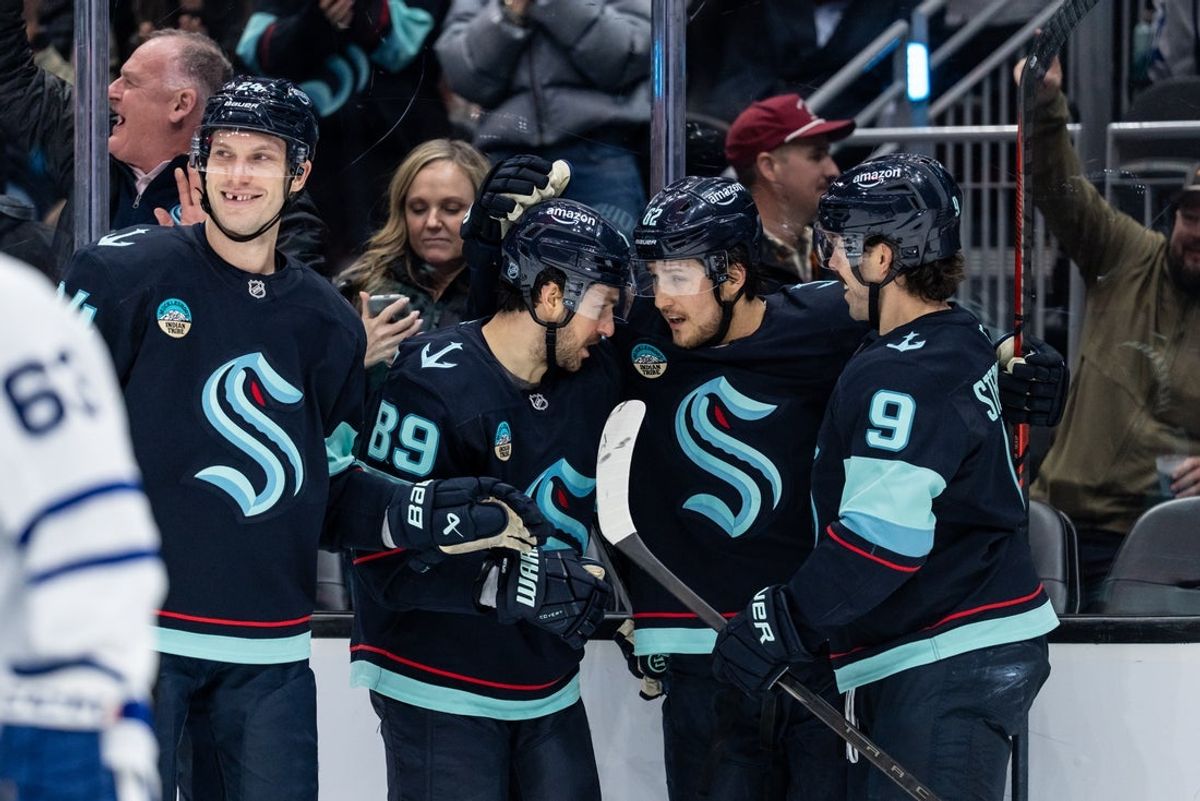Jan 29, 2026; Seattle, Washington, USA; Seattle Kraken, from left, defenseman Jamie Oleksiak (24), forward Frederick Gaudreau (89), defenseman Brandon Montour (62) and forward Chandler Stephenson (9) celebrate a goal during the second period at Climate Pledge Arena. Mandatory Credit: Stephen Brashear-Imagn Images