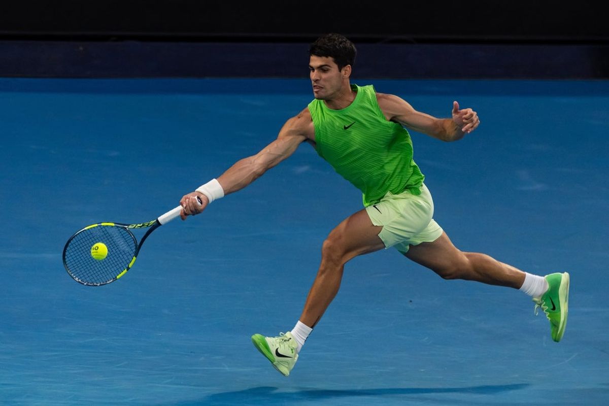 Jan 30, 2026; Melbourne, Victoria, Australia; Carlos Alcaraz of Spain in action against Alexander Zverev of Germany in the semifinals of the menís singles at the Australian Open at Rod Laver Arena in Melbourne Park. Mandatory Credit: Mike Frey-Imagn Images
