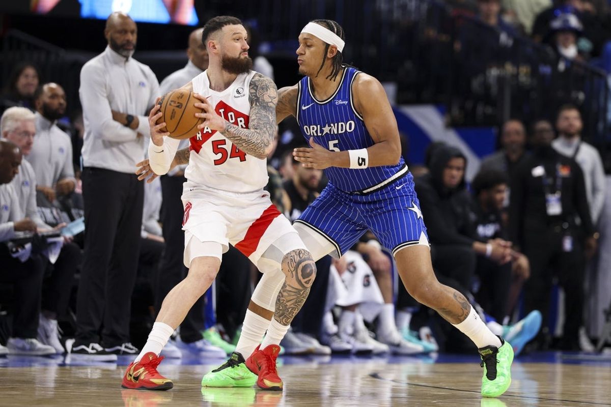 Jan 30, 2026; Orlando, Florida, USA; Toronto Raptors forward Sandro Mamukelashvili (54) is guarded by Orlando Magic forward Paolo Banchero (5) in the second quarter at Kia Center. Mandatory Credit: Nathan Ray Seebeck-Imagn Images