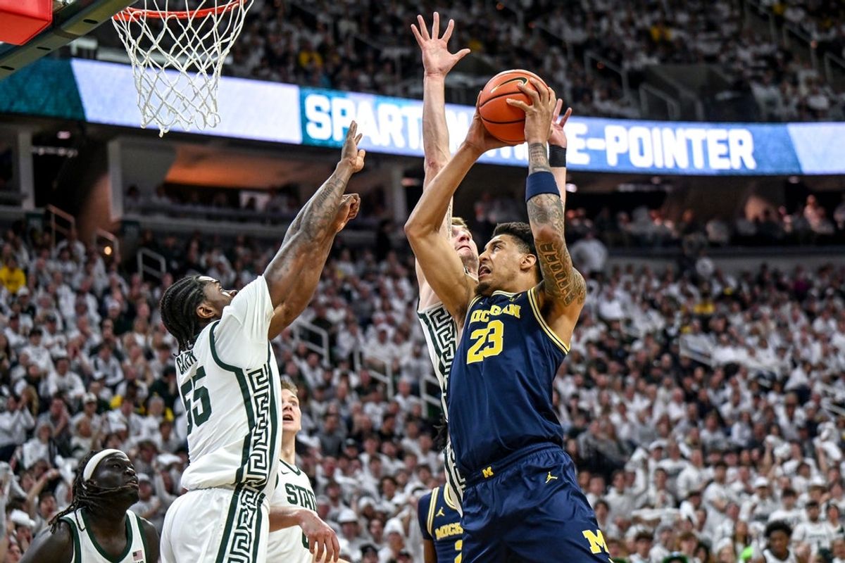 Michigan State's Coen Carr, left, and Carson Cooper, center, guard Michigan's Yaxel Lendeborg during the first half on Friday, Jan. 30, 2026, at the Breslin Center in East Lansing.