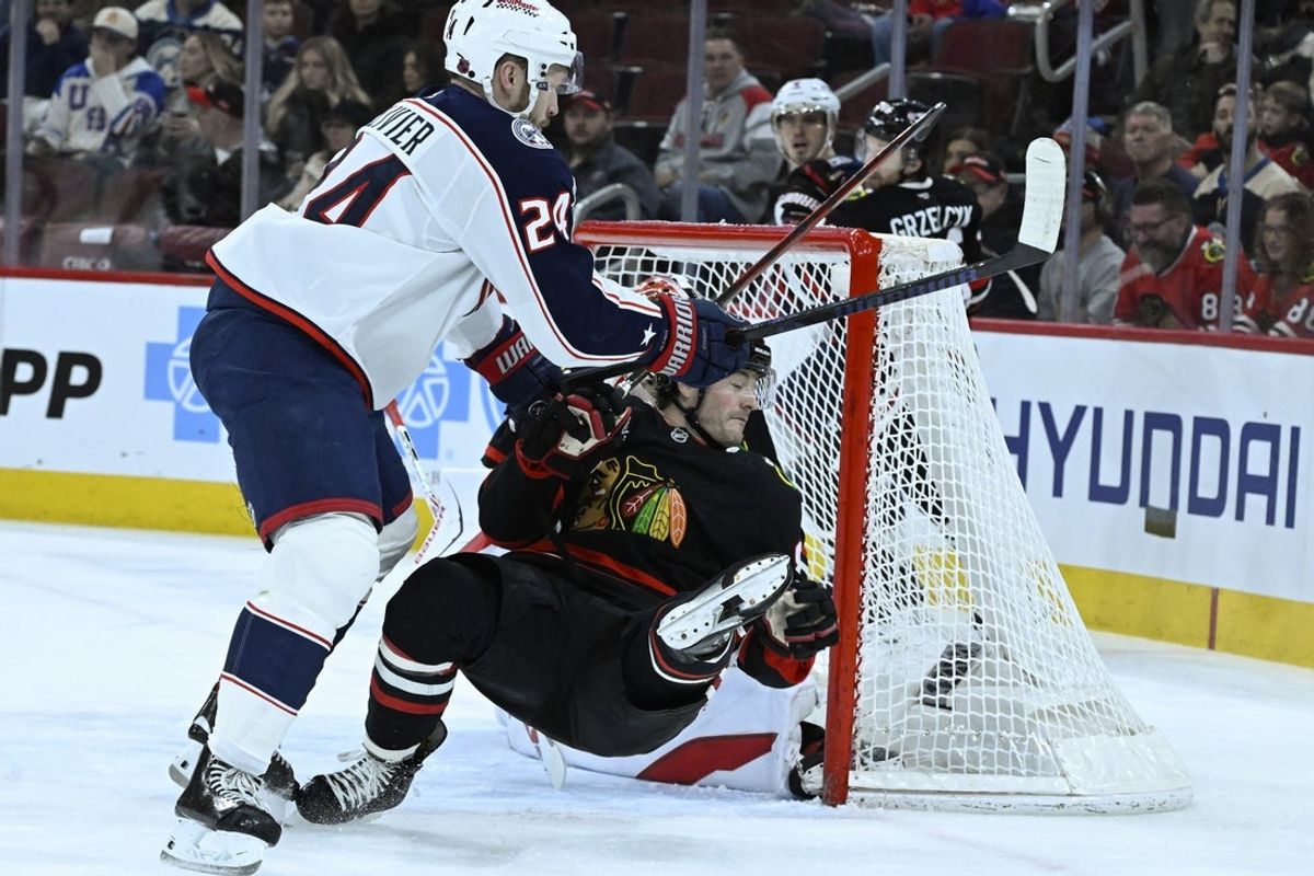 Jan 30, 2026; Chicago, Illinois, USA;  Columbus Blue Jackets right wing Mathieu Olivier (24) knocks down Chicago Blackhawks center Ryan Donato (8) during the first period at the United Center. Mandatory Credit: Matt Marton-Imagn Images