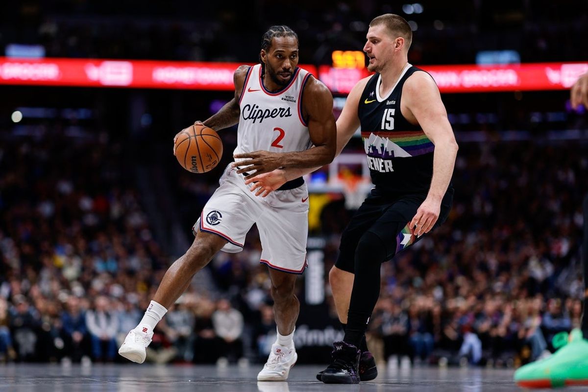 Jan 30, 2026; Denver, Colorado, USA; Los Angeles Clippers forward Kawhi Leonard (2) controls the ball as Denver Nuggets center Nikola Jokic (15) guards in the second quarter at Ball Arena. Mandatory Credit: Isaiah J. Downing-Imagn Images