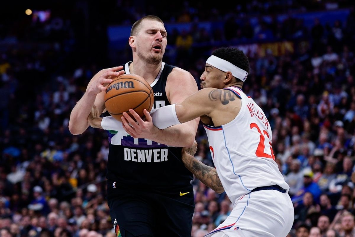Jan 30, 2026; Denver, Colorado, USA; Denver Nuggets center Nikola Jokic (15) is fouled by Los Angeles Clippers guard Jordan Miller (22) in the fourth quarter at Ball Arena. Mandatory Credit: Isaiah J. Downing-Imagn Images