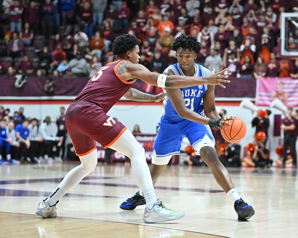 Jan 31, 2026; Blacksburg, Virginia, USA;  Duke Blue Devils center Patrick Ngongba (21) looks to pass the ball as Virginia Tech Hokies forward Amani Hansberry (13) defends during the first half at Cassell Coliseum. Mandatory Credit: Brian Bishop-Imagn Images