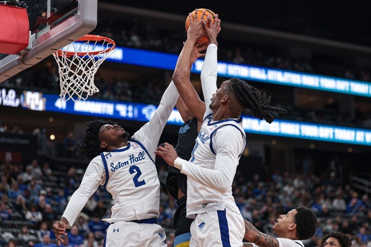 Jan 31, 2026; Newark, New Jersey, USA; Marquette Golden Eagles forward Royce Parham (13) goes to the basket against Seton Hall Pirates guard Tajuan Simpkins (2) and forward Stephon Payne III (6) during the first half at Prudential Center. Mandatory Credit: Vincent Carchietta-Imagn Images