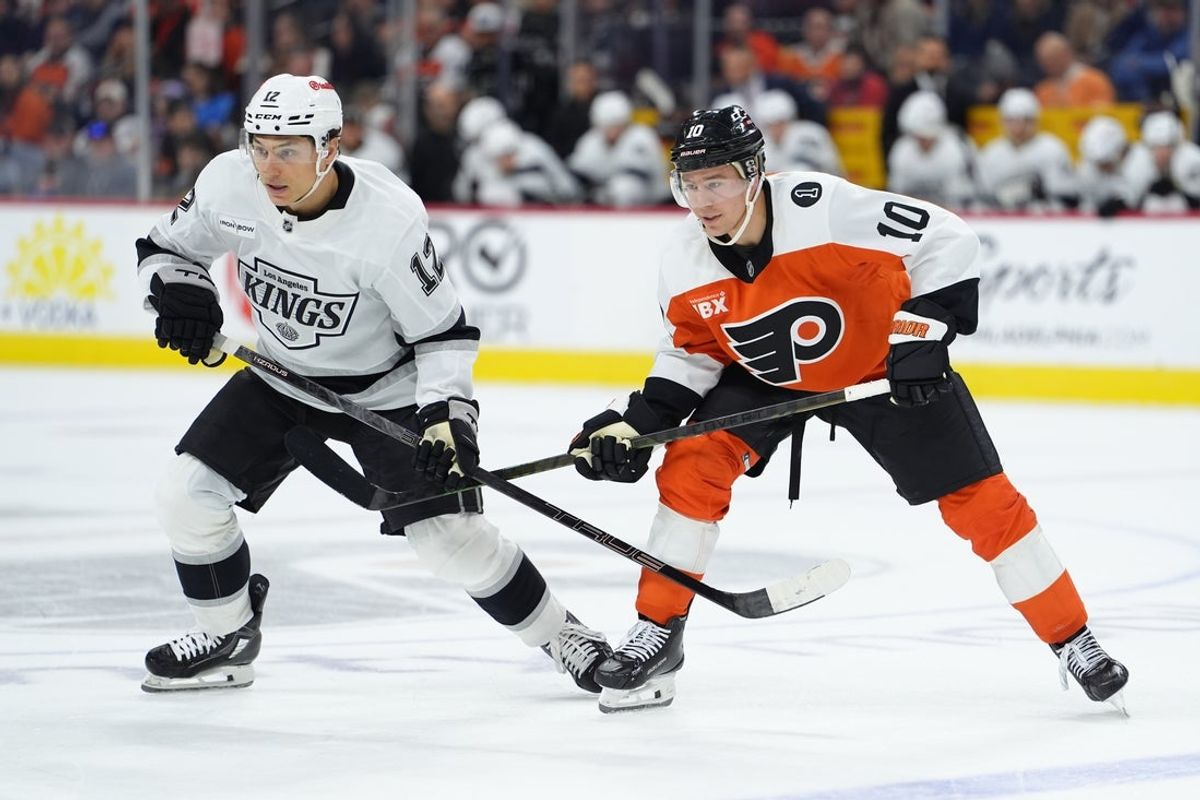 Jan 31, 2026; Philadelphia, Pennsylvania, USA; Los Angeles Kings left wing Trevor Moore (12) and Philadelphia Flyers right wing Bobby Brink (10) battle for position in the first period at Xfinity Mobile Arena. Mandatory Credit: Kyle Ross-Imagn Images