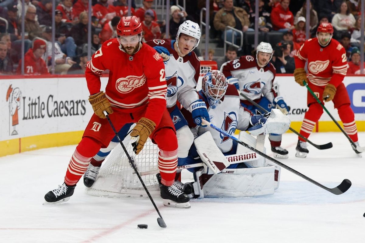 Jan 31, 2026; Detroit, Michigan, USA;  Detroit Red Wings center Michael Rasmussen (27) and Colorado Avalanche defenseman Josh Manson (42) battle for the puck in the second period at Little Caesars Arena. Mandatory Credit: Rick Osentoski-Imagn Images