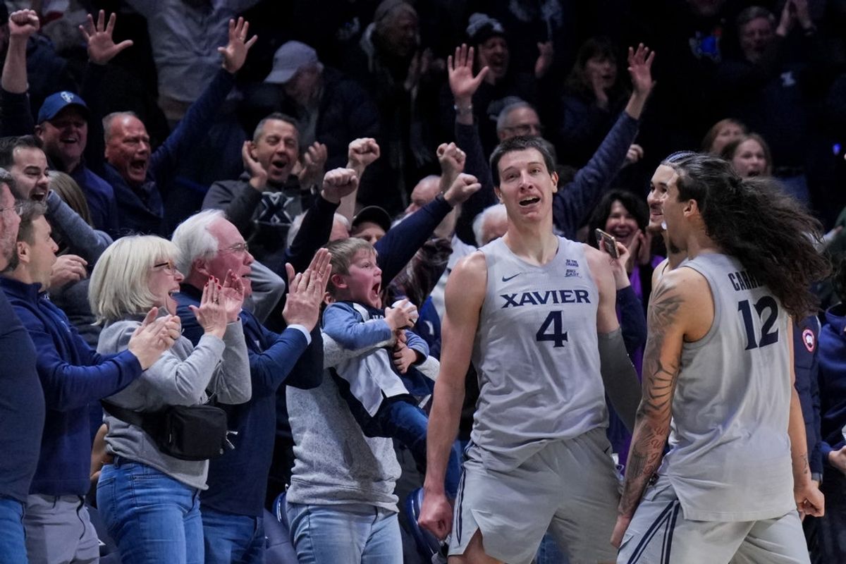 Jan 31, 2026; Cincinnati, Ohio, USA;  Xavier Musketeers forward Filip Borovicanin (4) celebrates with teammates after making the game-winning basket against the DePaul Blue Demons at the Cintas Center. Mandatory Credit: Aaron Doster-Imagn Images