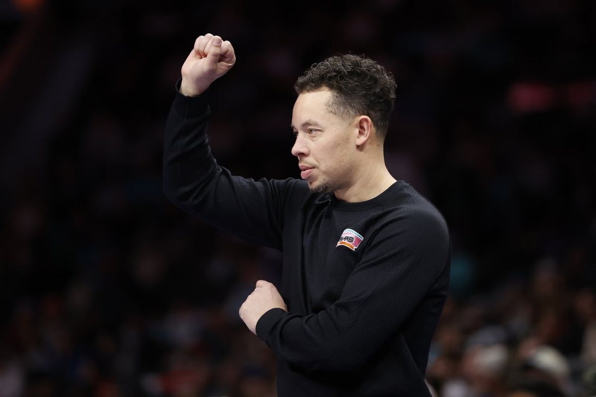 Jan 31, 2026; Charlotte, North Carolina, USA; San Antonio Spurs head coach Mitch Johnson calls a play during second half action against the Charlotte Hornets at Spectrum Center. Mandatory Credit: Brian Westerholt-Imagn Images