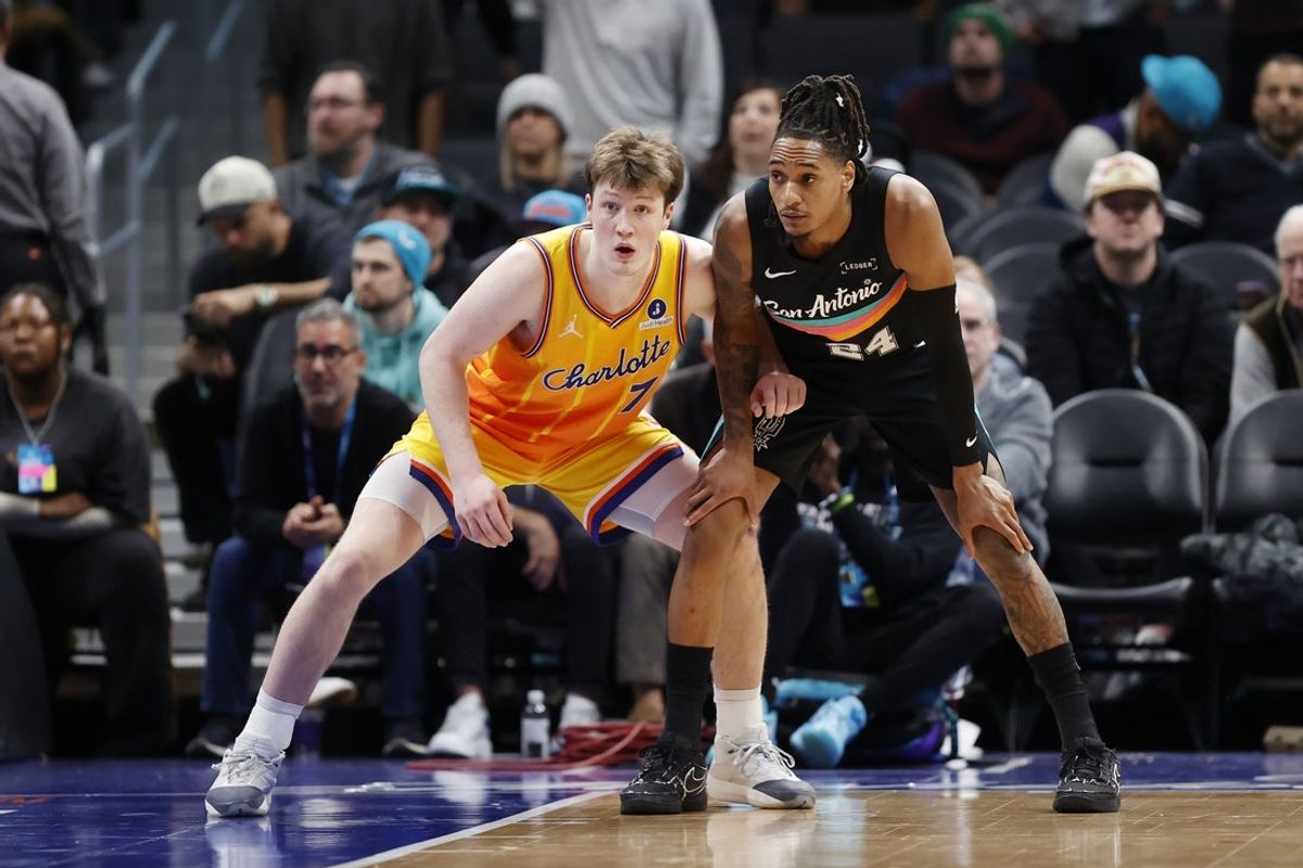 Jan 31, 2026; Charlotte, North Carolina, USA; Charlotte Hornets guard Kon Knueppel (7) guards San Antonio Spurs guard Devin Vassell (24) during second half action at Spectrum Center. Mandatory Credit: Brian Westerholt-Imagn Images