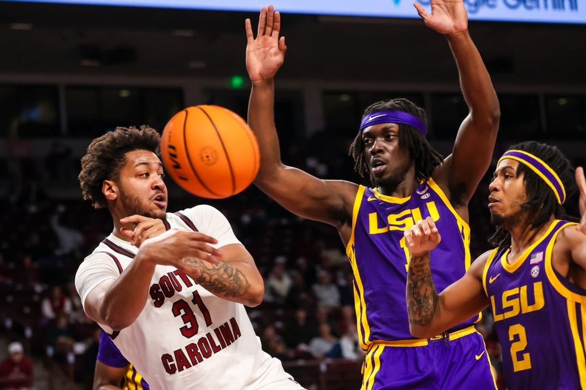 Jan 31, 2026; Columbia, South Carolina, USA; South Carolina Gamecocks forward Elijah Strong (31) passes away from Louisiana State Tigers center Michael Nwoko (1) and guard Jalen Reece (2) in the first half at Colonial Life Arena. Mandatory Credit: Jeff Blake-Imagn Images