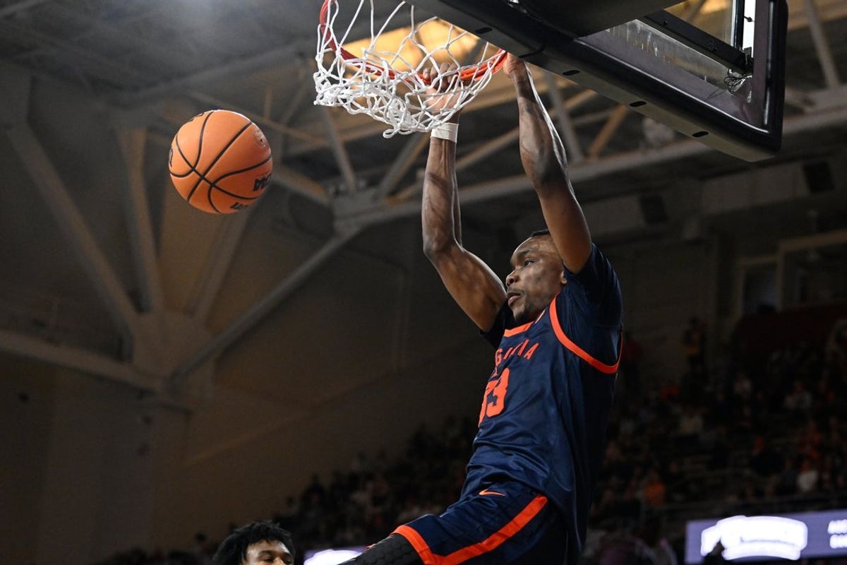 Jan 31, 2026; Chestnut Hill, Massachusetts, USA; Virginia Cavaliers center Ugonna Onyenso (33) hangs from the rim after dunking the ball against the Boston College Eagles during the second half at Conte Forum. Mandatory Credit: Eric Canha-Imagn Images