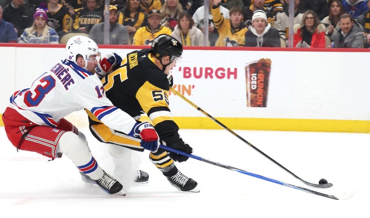Jan 31, 2026; Pittsburgh, Pennsylvania, USA;  Pittsburgh Penguins center Noel Acciari (55) moves the puck against pressure from New York Rangers left wing Alexis Lafrenière (13) during the first period at PPG Paints Arena. Mandatory Credit: Charles LeClaire-Imagn Images