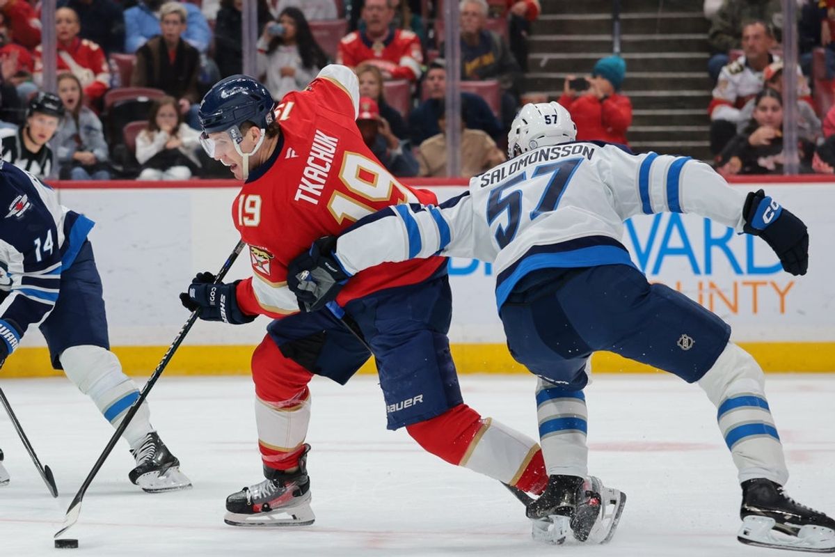 Jan 31, 2026; Sunrise, Florida, USA; Florida Panthers left wing Matthew Tkachuk (19) moves the puck against Winnipeg Jets defenseman Elias Salomonsson (57) during the second period at Amerant Bank Arena. Mandatory Credit: Sam Navarro-Imagn Images