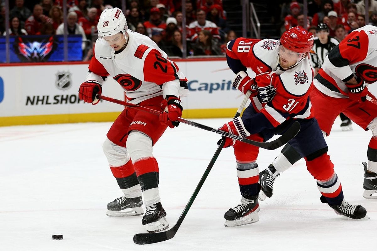 Jan 31, 2026; Washington, District of Columbia, USA; Washington Capitals defenseman Rasmus Sandin (38) takes a shot past Carolina Hurricanes center Sebastian Aho (20) during the first period at Capital One Arena. Mandatory Credit: Daniel Kucin Jr.-Imagn Images