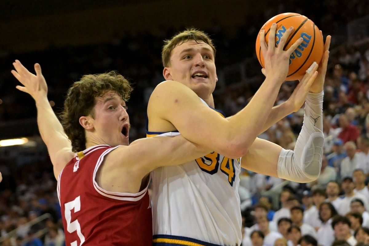 Jan 31, 2026; Los Angeles, California, USA;  UCLA Bruins forward Tyler Bilodeau (34) is fouled by Indiana Hoosiers guard Conor Enright (5) in the first half at Pauley Pavilion presented by Wescom Financial. Mandatory Credit: Jayne Kamin-Oncea-Imagn Images