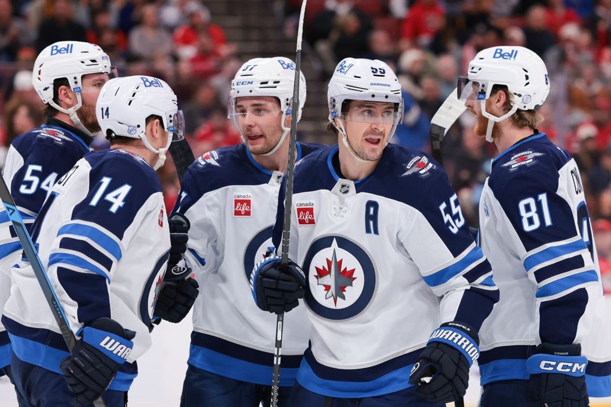 Jan 31, 2026; Sunrise, Florida, USA; Winnipeg Jets center Mark Scheifele (55) celebrates with teammates after scoring against the Florida Panthers during the third period at Amerant Bank Arena. Mandatory Credit: Sam Navarro-Imagn Images