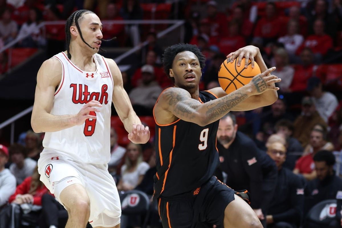 Jan 31, 2026; Salt Lake City, Utah, USA; Oklahoma State Cowboys guard Anthony Roy (9) drives to the basket against Utah Utes guard Jerry Huang (9) during the first half at Jon M. Huntsman Center. Mandatory Credit: Rob Gray-Imagn Images