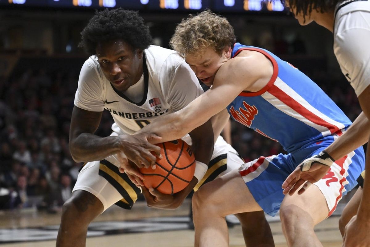 Jan 31, 2026; Nashville, TN, USA;  Vanderbilt Commodores guard Mike James (0) and Mississippi Rebels guard Zach Day (31) fight for the loose ball during the first half at Memorial Gymnasium. Mandatory Credit: Steve Roberts-Imagn Images