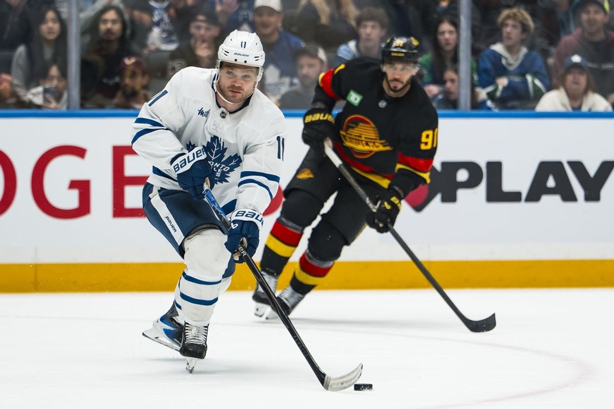 Jan 31, 2026; Vancouver, British Columbia, CAN; Toronto Maple Leafs forward Max Domi (11) handles the puck against the Vancouver Canucks in the first period at Rogers Arena. Mandatory Credit: Bob Frid-Imagn Images