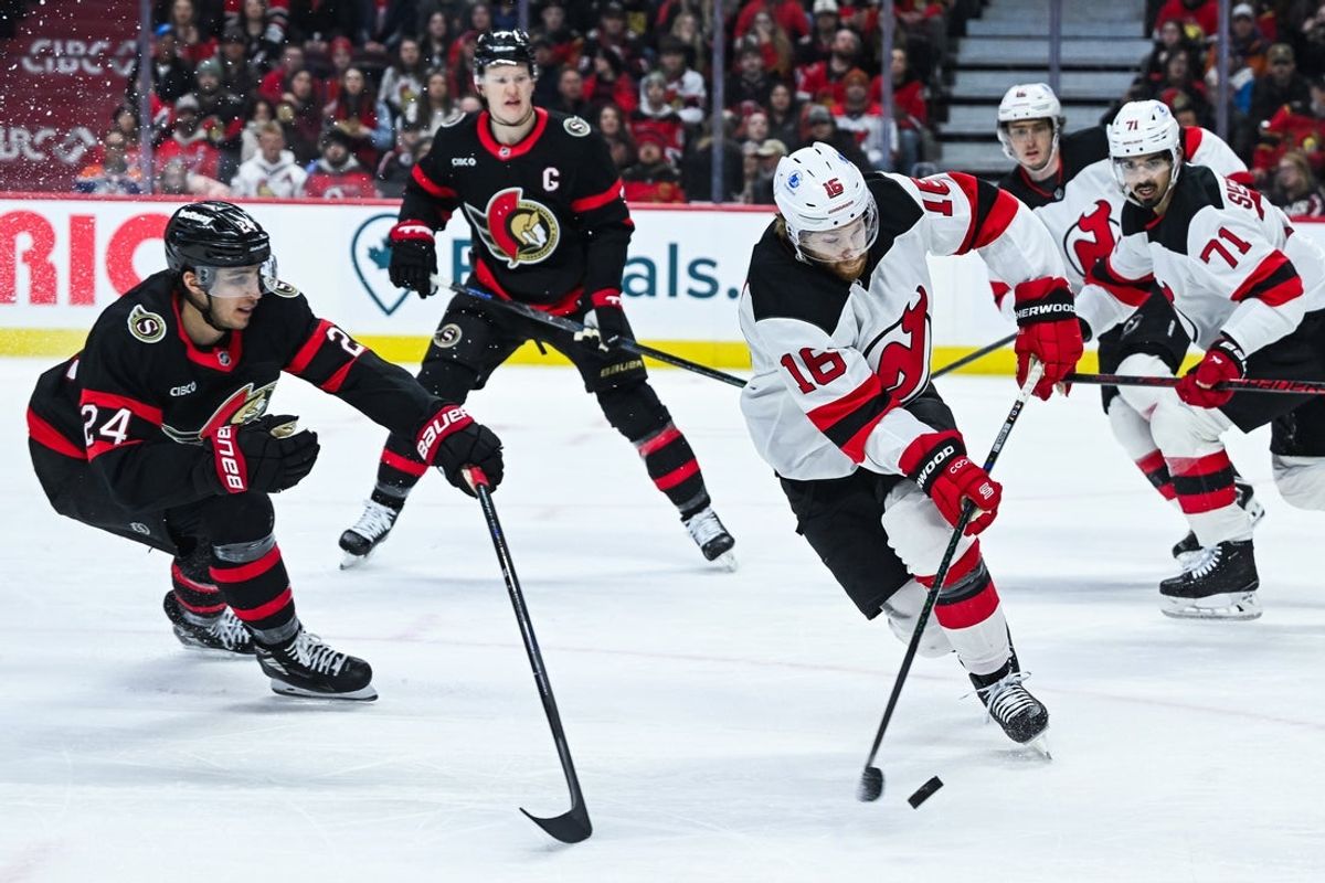 Jan 31, 2026; Ottawa, Ontario, CAN; New Jersey Devils right wing Connor Brown (16) defends the puck against Ottawa Senators center Dylan Cozens (24) during the first period at Canadian Tire Centre. Mandatory Credit: David Kirouac-Imagn Images
