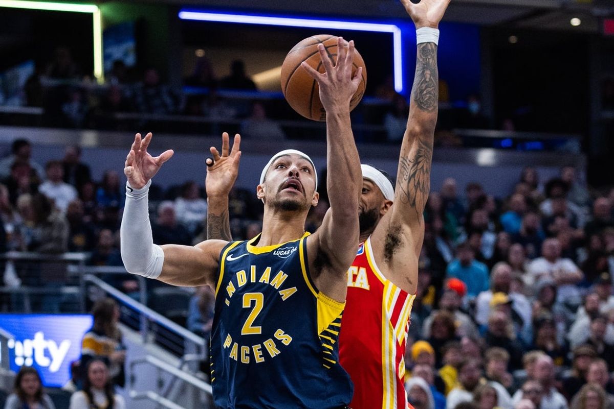 Jan 31, 2026; Indianapolis, Indiana, USA; Indiana Pacers guard/forward Andrew Nembhard (2) shoots the ball while Atlanta Hawks guard Nickeil Alexander-Walker (7) defends in the first half at Gainbridge Fieldhouse. Mandatory Credit: Trevor Ruszkowski-Imagn Images