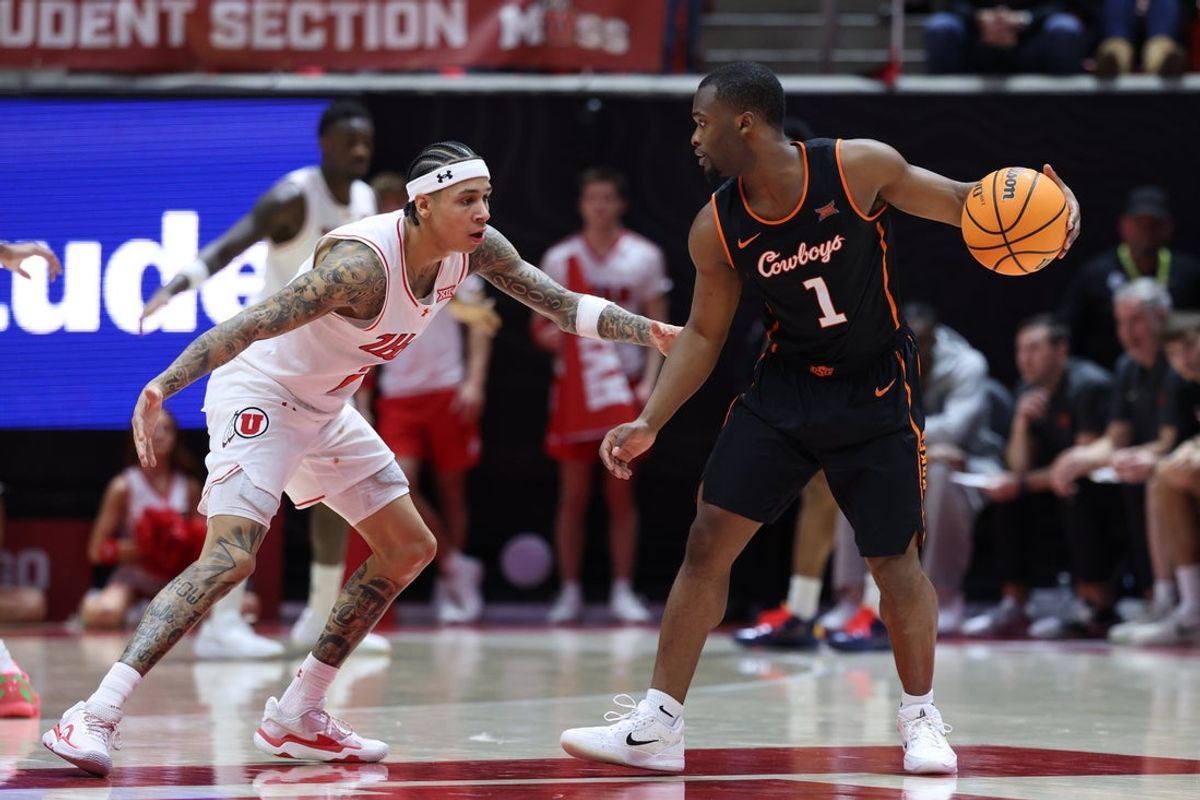 Jan 31, 2026; Salt Lake City, Utah, USA; Oklahoma State Cowboys guard Kanye Clary (1) looks for the play against Utah Utes guard Terrence Brown (2) during the second half at Jon M. Huntsman Center. Mandatory Credit: Rob Gray-Imagn Images