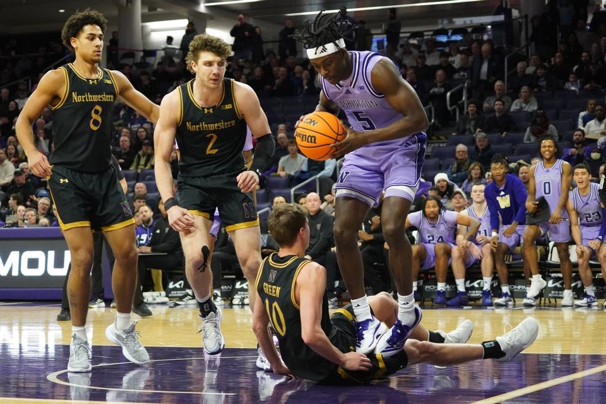 Jan 31, 2026; Evanston, Illinois, USA; Washington Huskies guard Zoom Diallo (5) grabs rebound over Northwestern Wildcats guard Max Green (10) during the first half at Welsh-Ryan Arena. Mandatory Credit: David Banks-Imagn Images