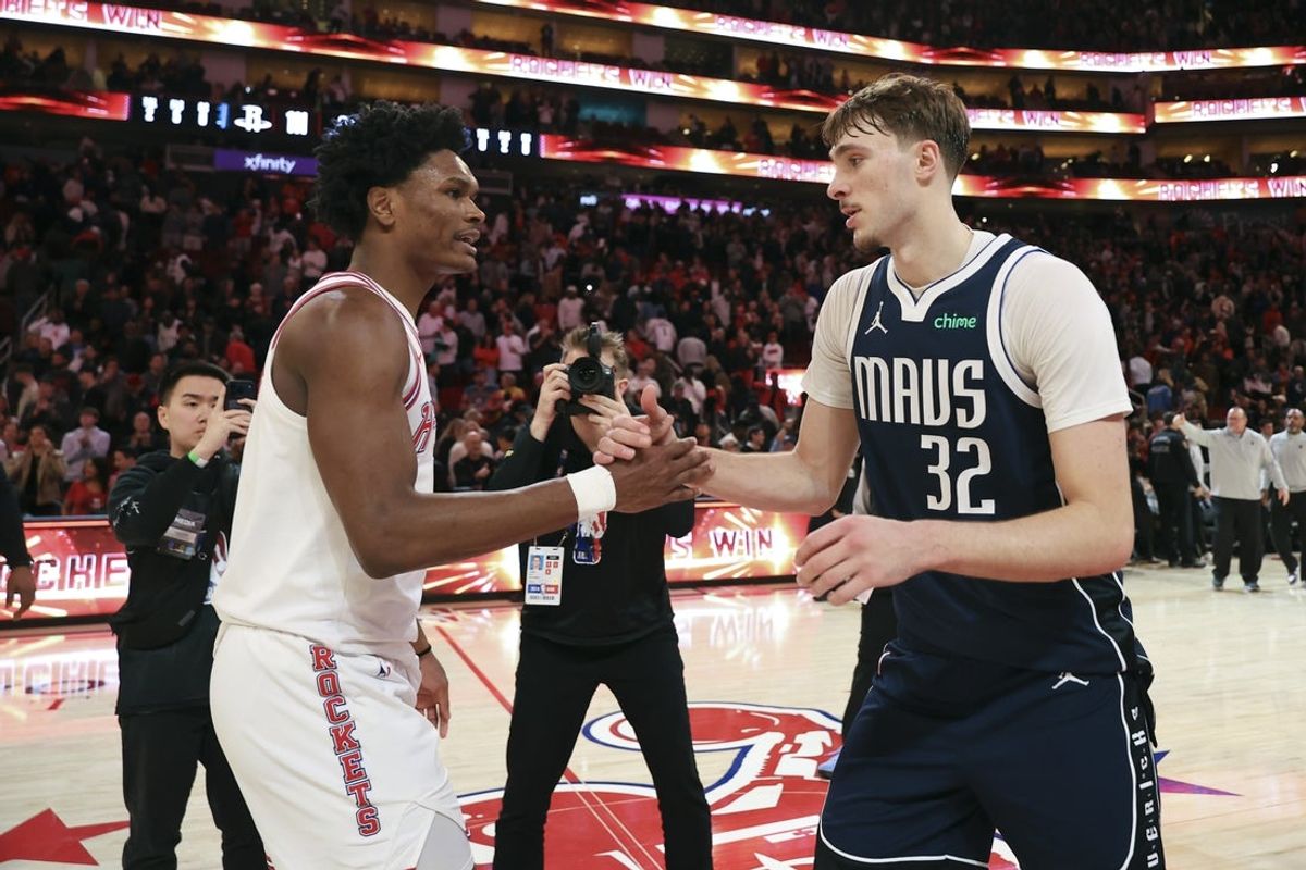 Jan 31, 2026; Houston, Texas, USA; Houston Rockets guard Amen Thompson (1) and Dallas Mavericks forward Cooper Flagg (32) shake hands after the game at Toyota Center. Mandatory Credit: Troy Taormina-Imagn Images
