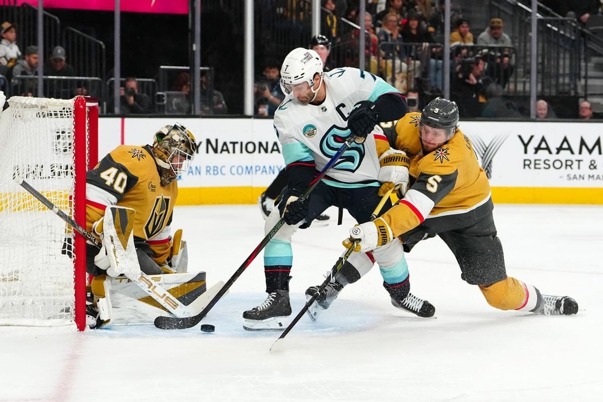 Jan 31, 2026; Las Vegas, Nevada, USA; Vegas Golden Knights goaltender Akira Schmid (40) defends his net as defenseman Jeremy Lauzon (5) breaks up a scoring attempt by Seattle Kraken right wing Jordan Eberle (7) during the second period at T-Mobile Arena. Mandatory Credit: Stephen R. Sylvanie-Imagn Images