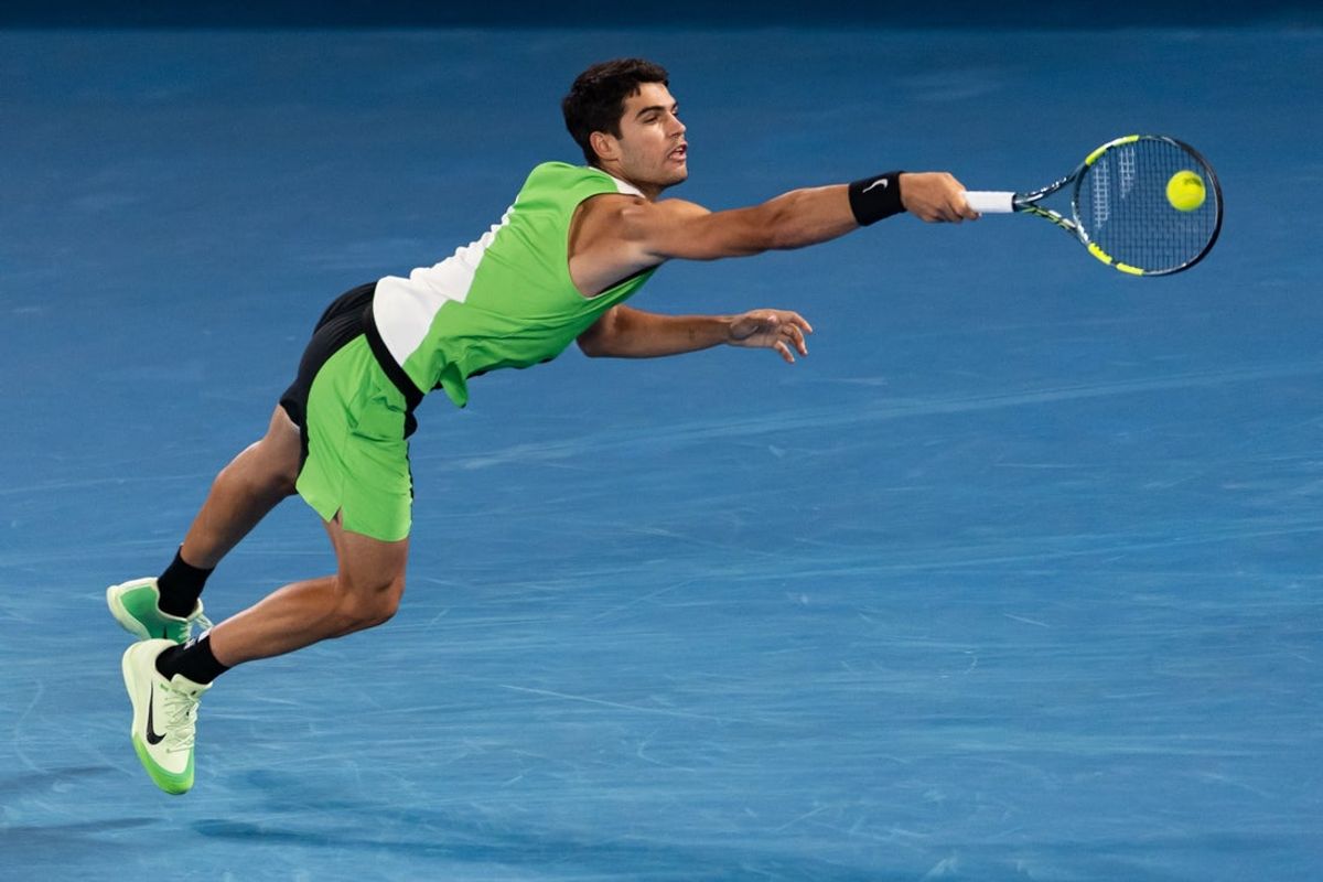 Feb 01, 2026; Melbourne, Victoria, Australia; Carlos Alcaraz of Spain in action against Novak Djokovic of Serbia in the final of the menís singles at the Australian Open at Rod Laver Arena in Melbourne Park. Mandatory Credit: Mike Frey-Imagn Images